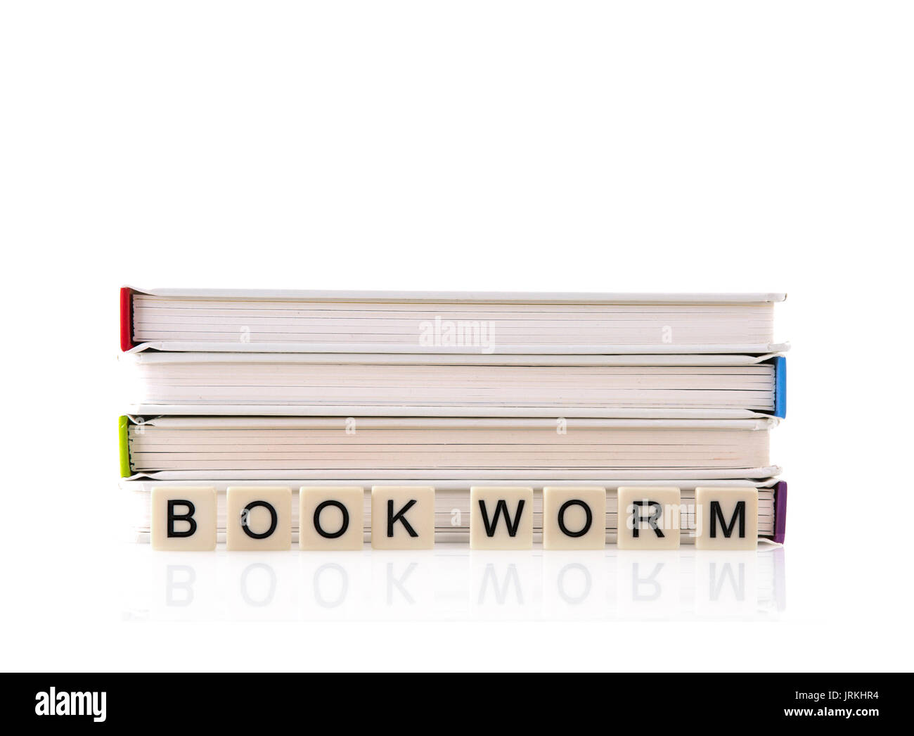 Pile of Books with Bookworm spelt out with word tiles on a white background Stock Photo