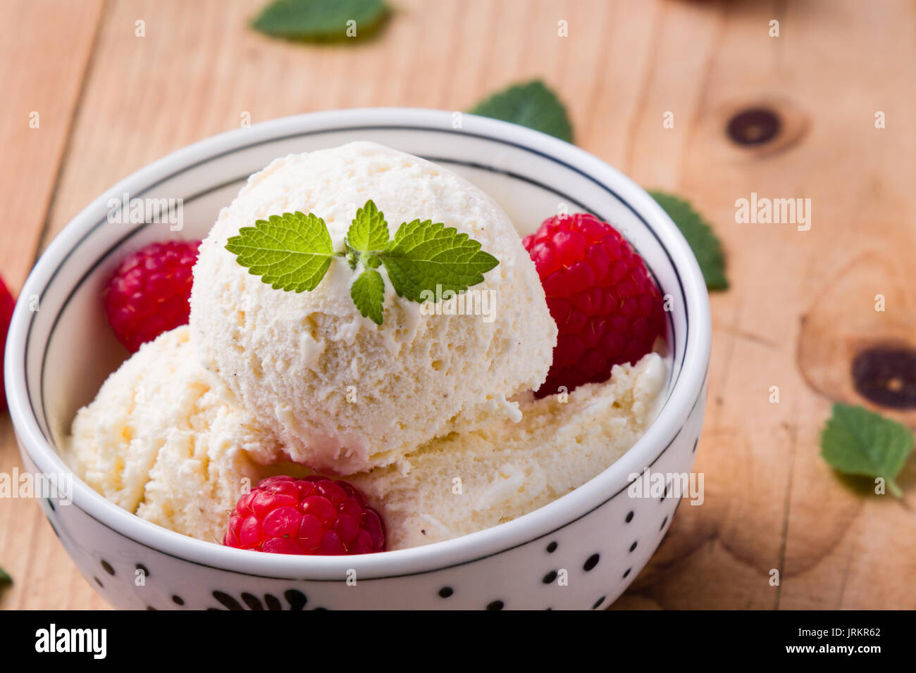 vanilla ice cream with fruits in a white bowl Stock Photo - Alamy