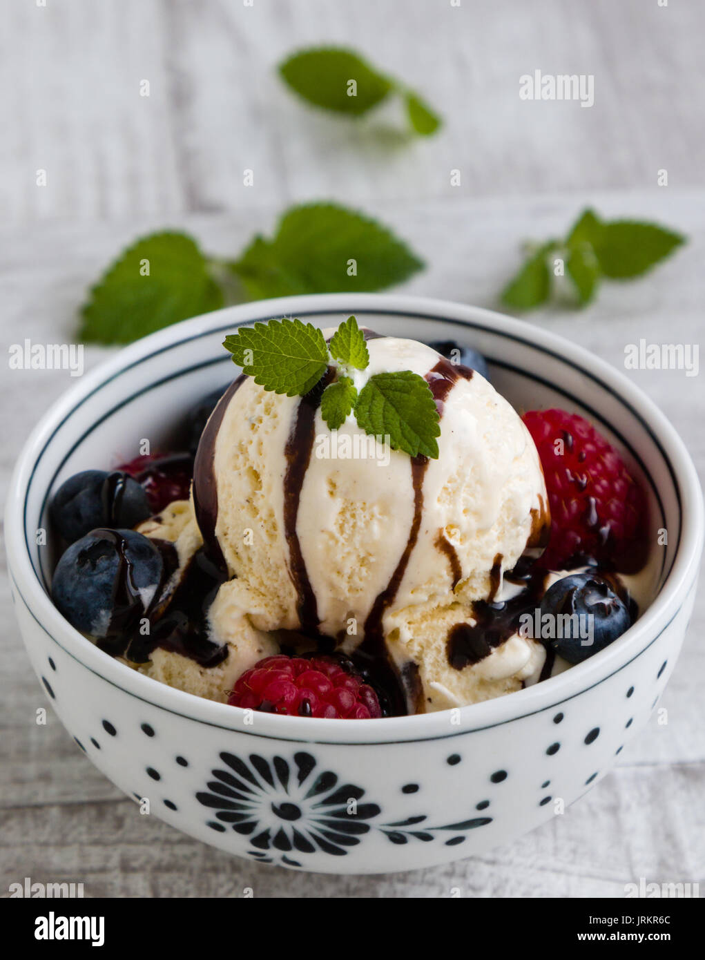 vanilla ice cream with fruits in a white bowl Stock Photo - Alamy