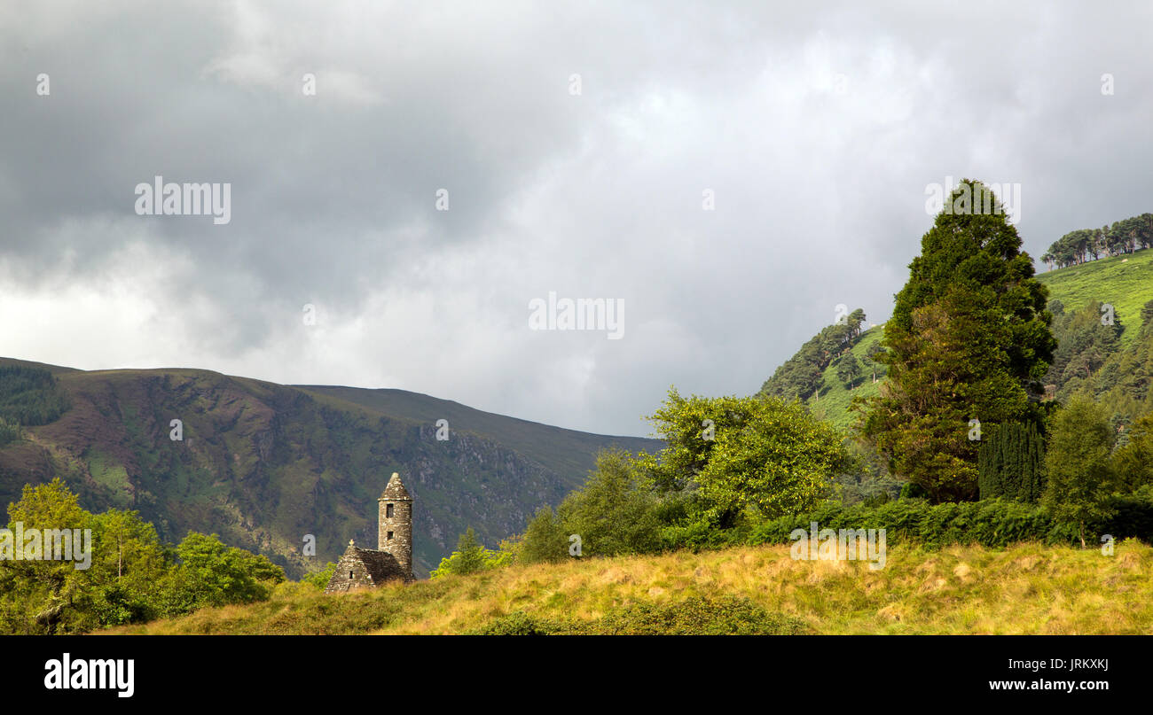 St. Kevin’s Kitchen (St. Kevin's Church), beneath a stormy sky at Glendalough Stock Photo