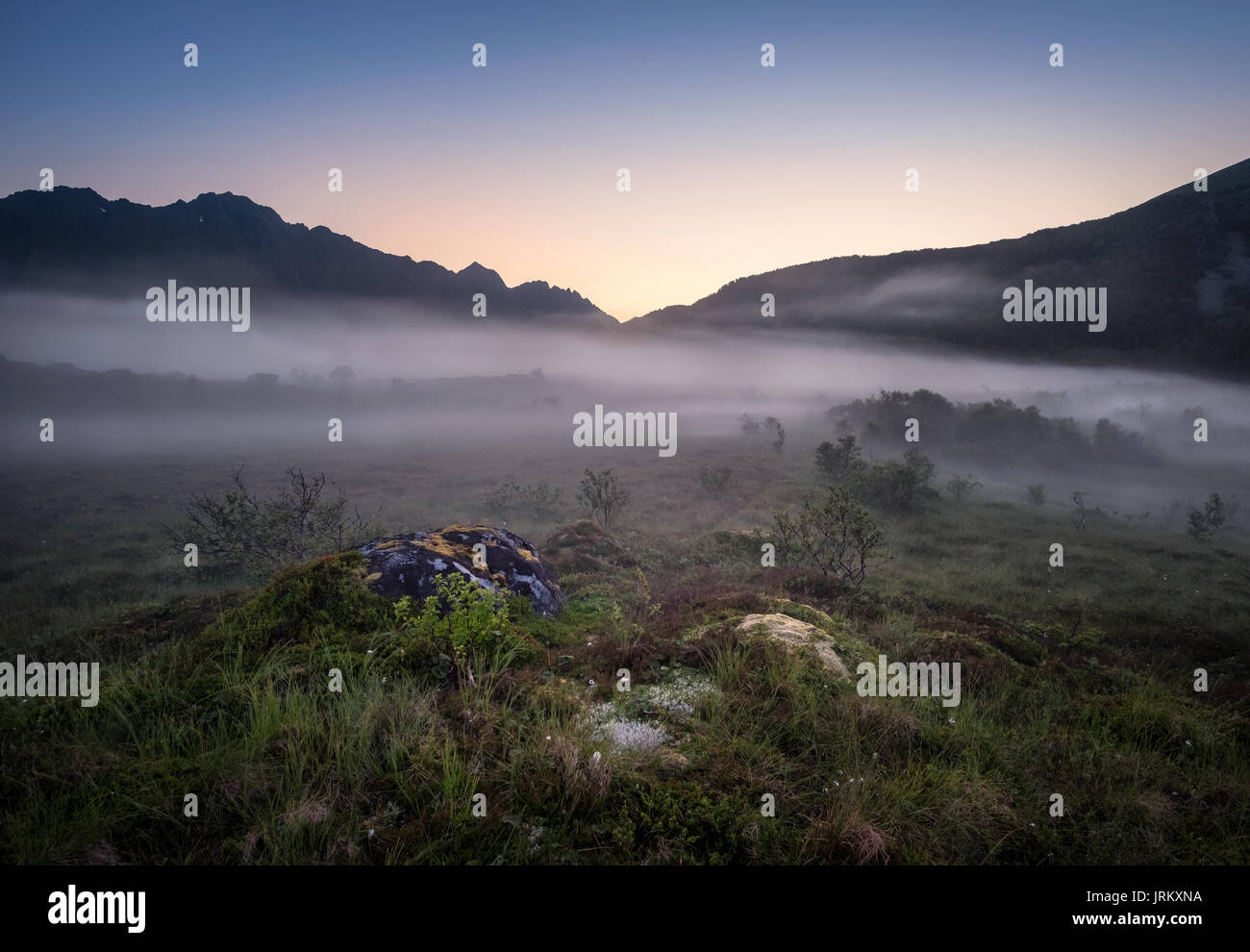Foggy view from Lofoten Norway at bright summer night. Stock Photo
