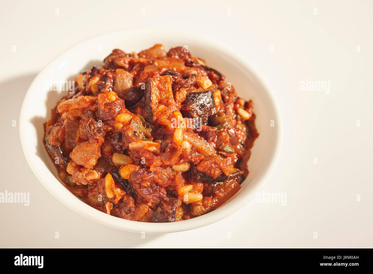 Caponata, a stew of eggplant, tomato, raisins and pine nuts, from Sicily, Italy Stock Photo
