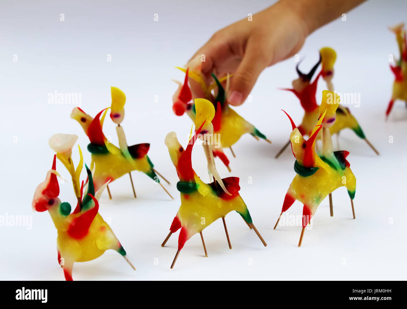 Boy play Tohe, the traditional toys in Vietnam made by colored rice