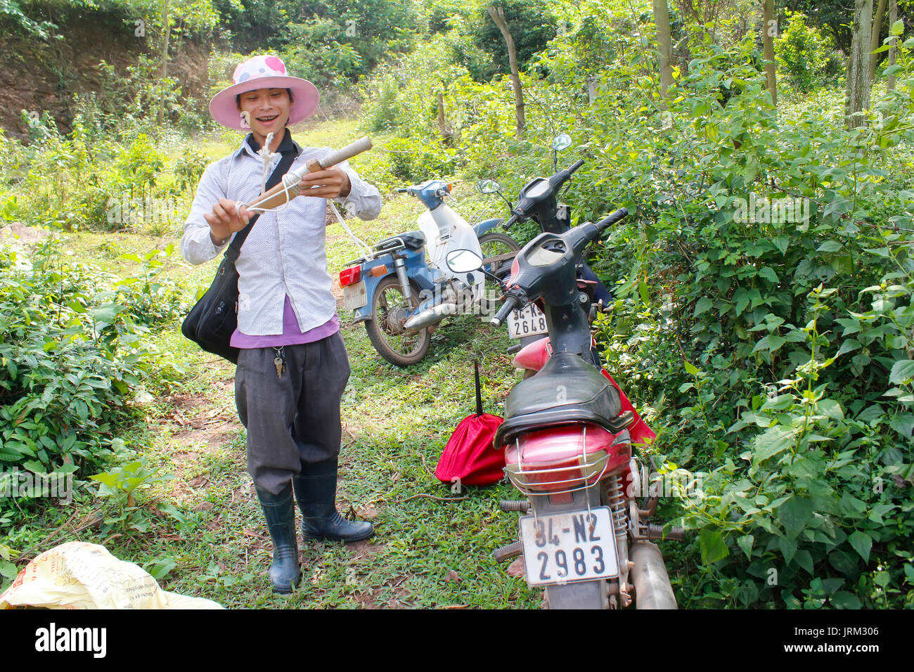 HAI DUONG, VIETNAM, May, 20: young man go trapping birds in the forest on May, 20, 2014 in Hai Duong, Vietnam. Stock Photo