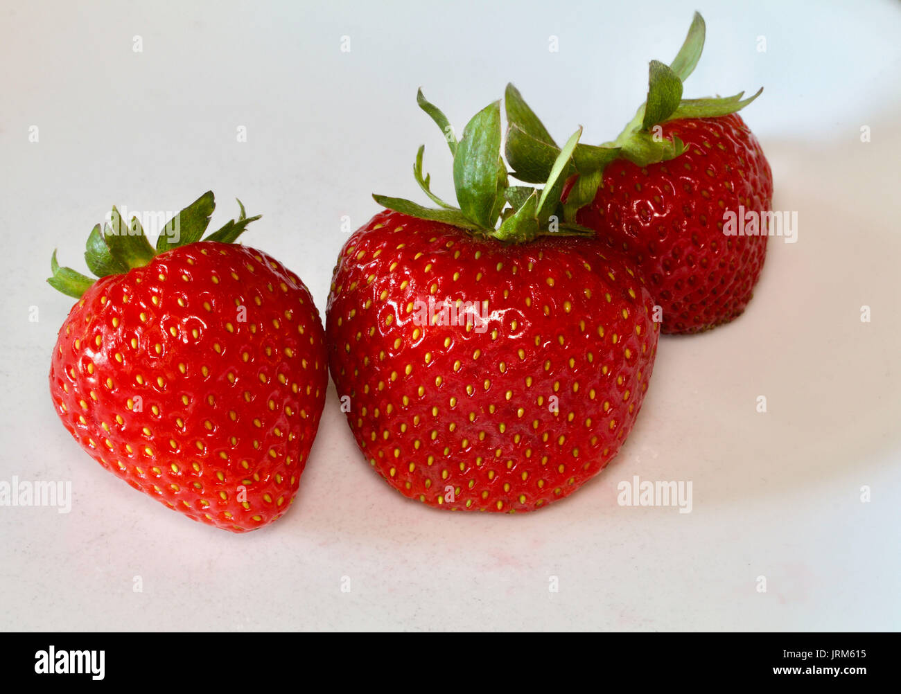 Group of bright red shiny strawberries hi-res stock photography and ...