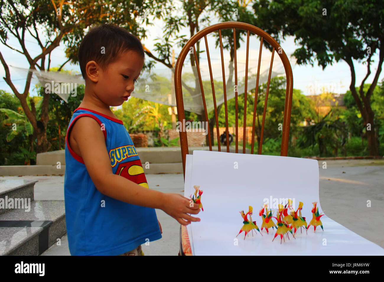 HAI DUONG, VIETNAM, September, 6: Boy play Tohe, the traditional toys in Vietnam made by colored rice powder on September, 6, 2014 in Hai Duong, Vietn Stock Photo