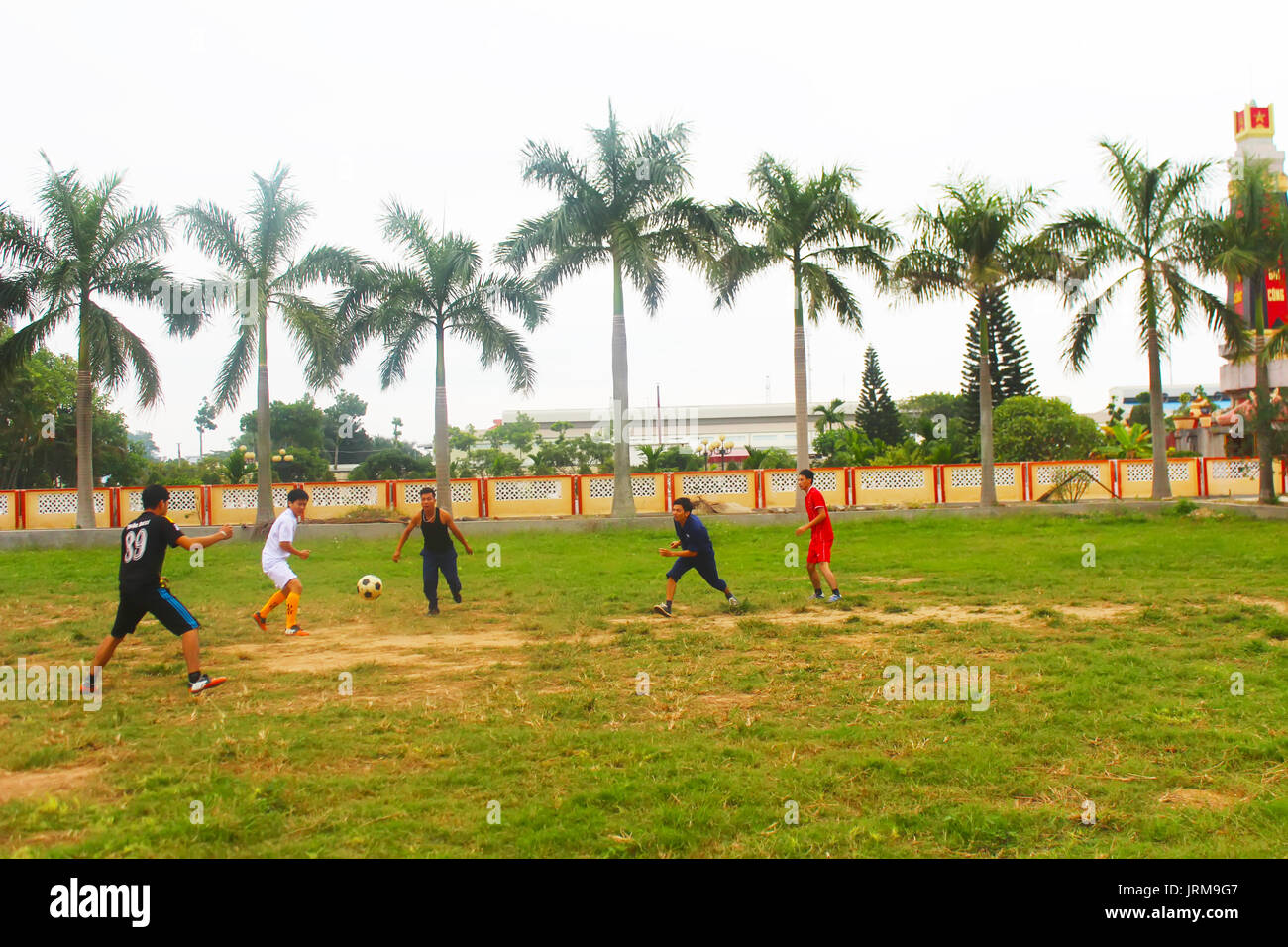 HAI DUONG, VIETNAM, DECEMBER, 1: Asian young people playing football on december, 1, 2014 in Hai Duong, Vietnam. Stock Photo