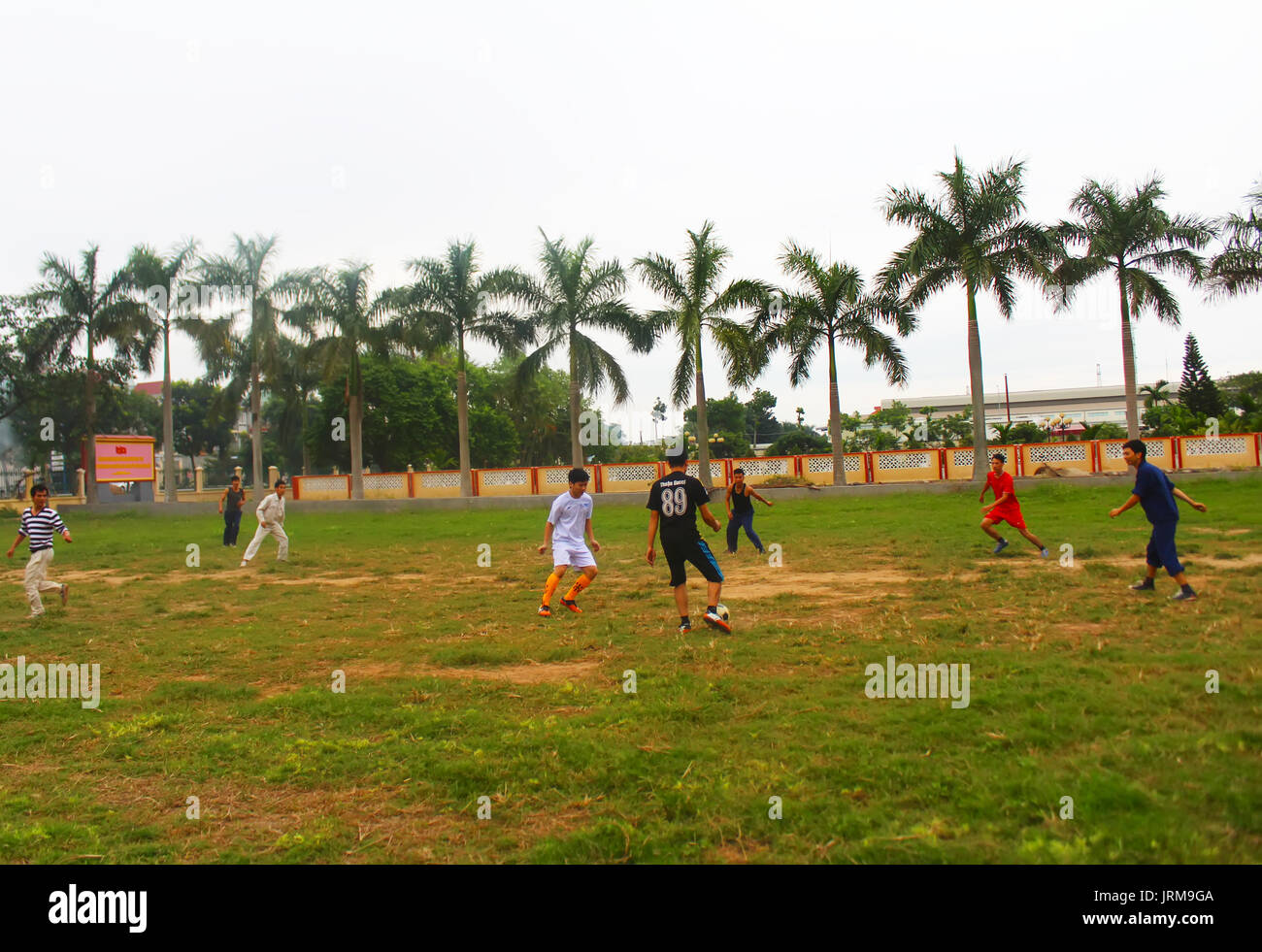 HAI DUONG, VIETNAM, DECEMBER, 1: Asian young people playing football on december, 1, 2014 in Hai Duong, Vietnam. Stock Photo