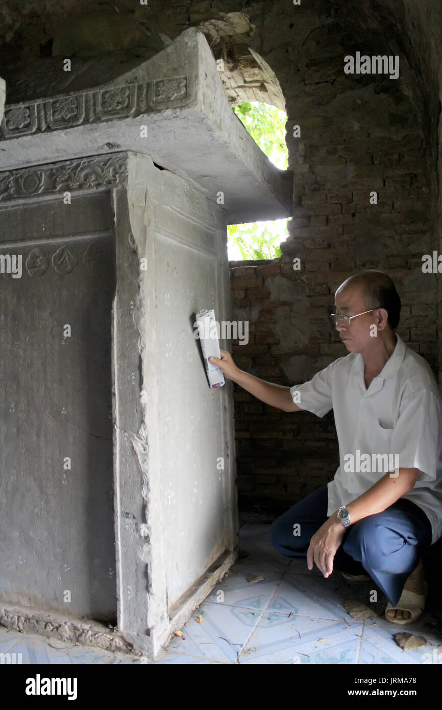 HAI DUONG, VIETNAM, September, 26: Old man reads epitaphs on September, 26, 2013 in Hai Duong, Vietnam Stock Photo