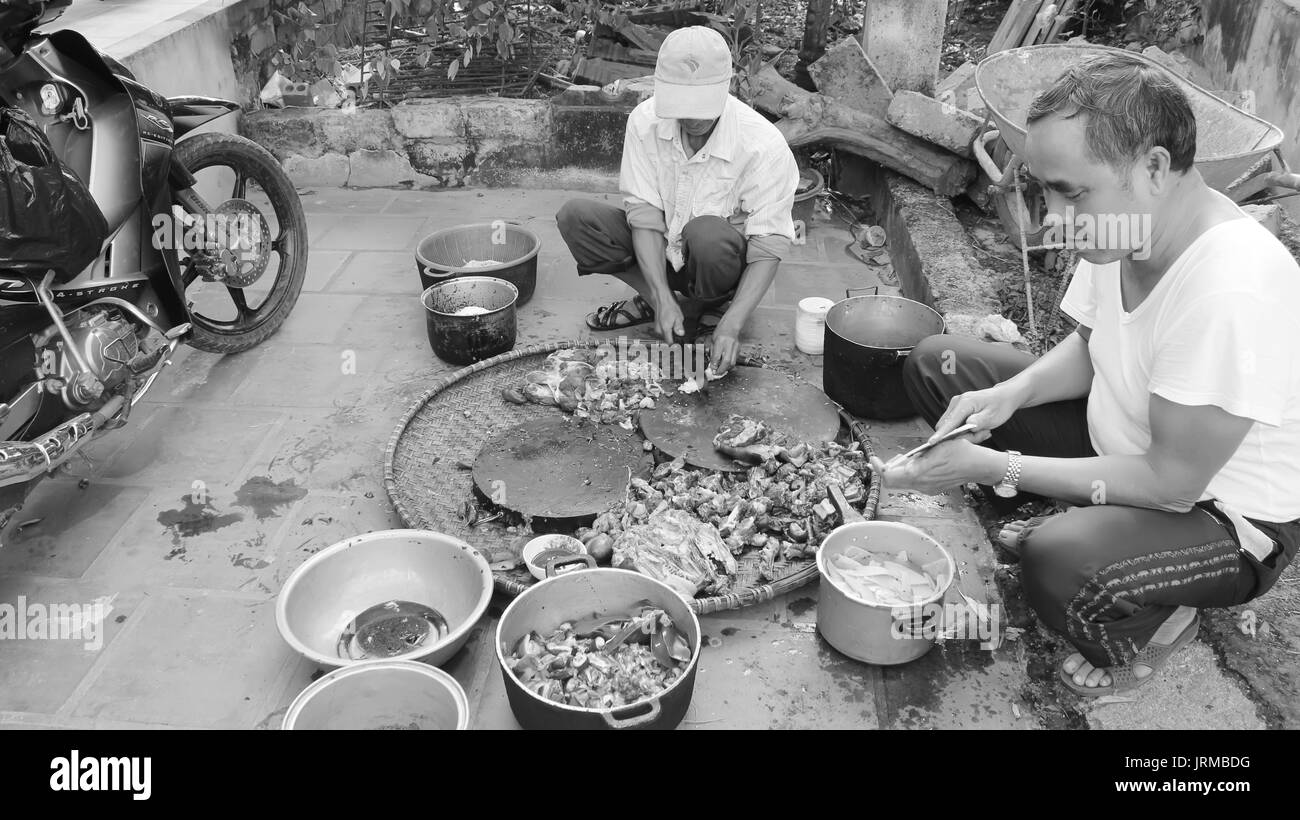 HAI DUONG, VIETNAM, November, 20: Asian men slaughtering dog to cook on November 20, 2013 in Hai Duong, Vietnam. Stock Photo