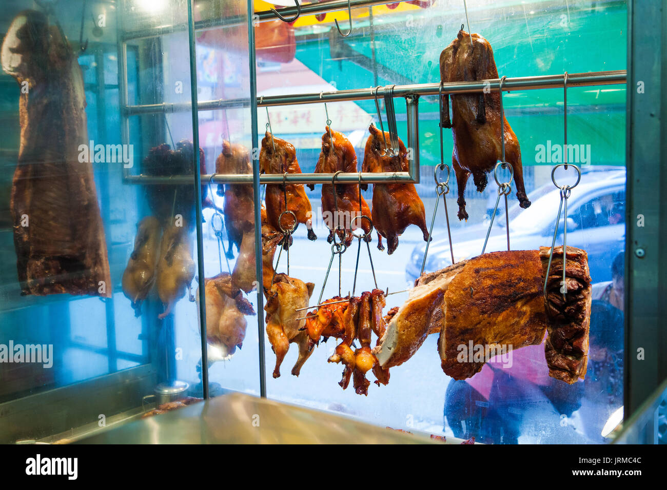 Roasted chicken and duck hanging in window of Dollar Meat Store in
