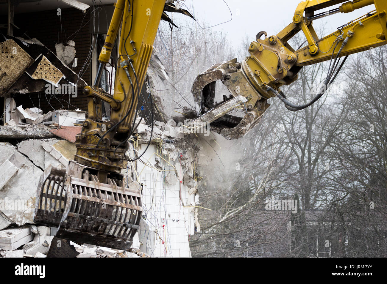 Demolition cranes dismantling a building Stock Photo