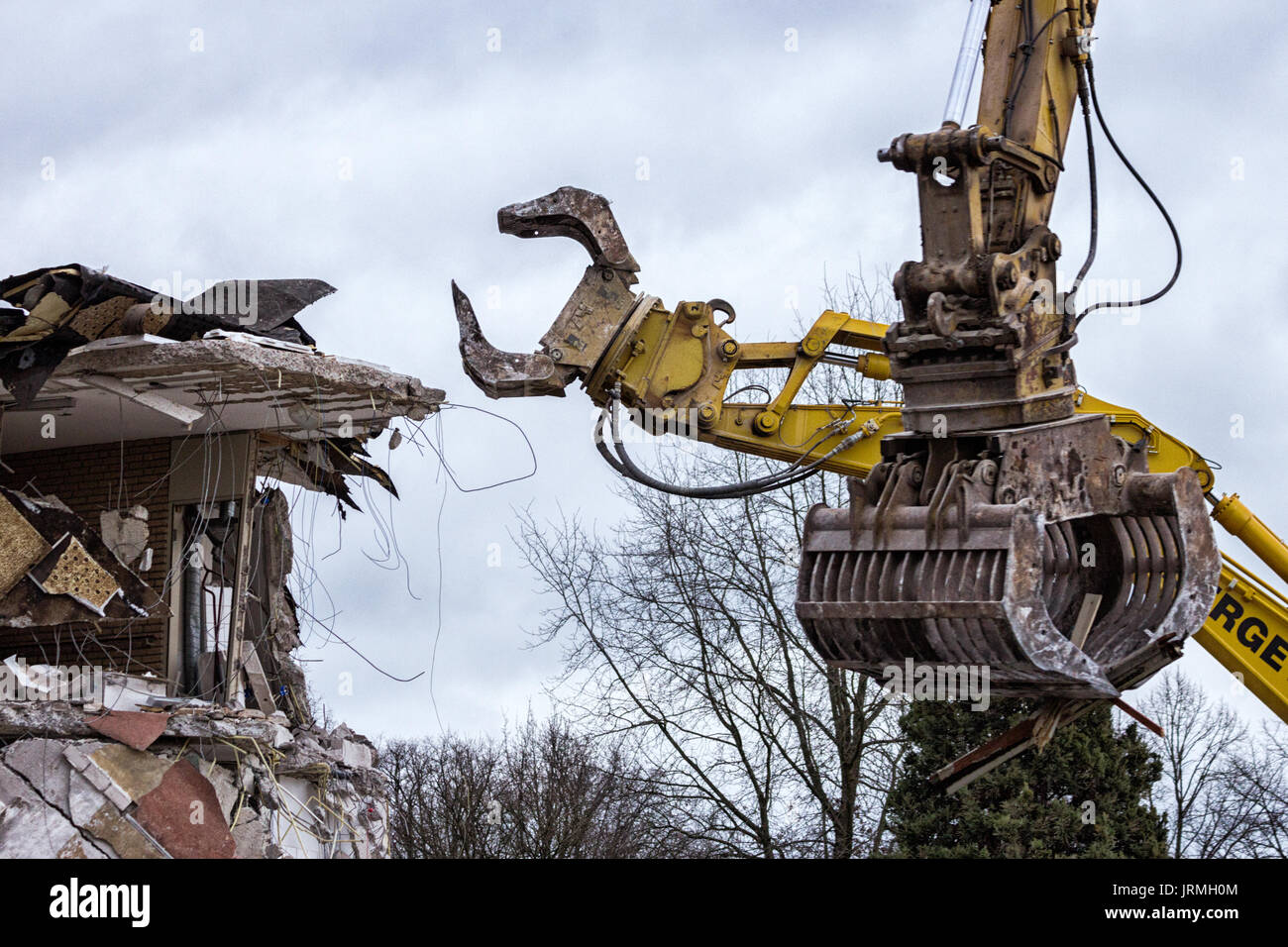 Demolition cranes dismantling a building Stock Photo