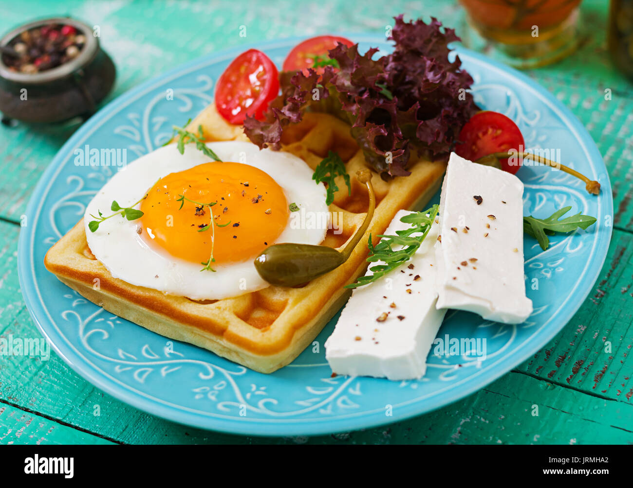 Healthy breakfast waffles, eggs, feta cheese, tomatoes and lettuce