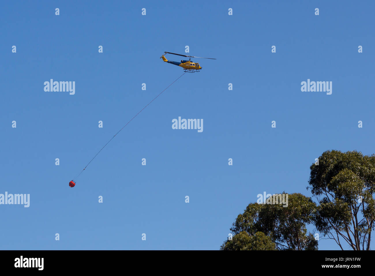 Tasmanian fire support helicopter going to help extinguish bushfire Stock Photo