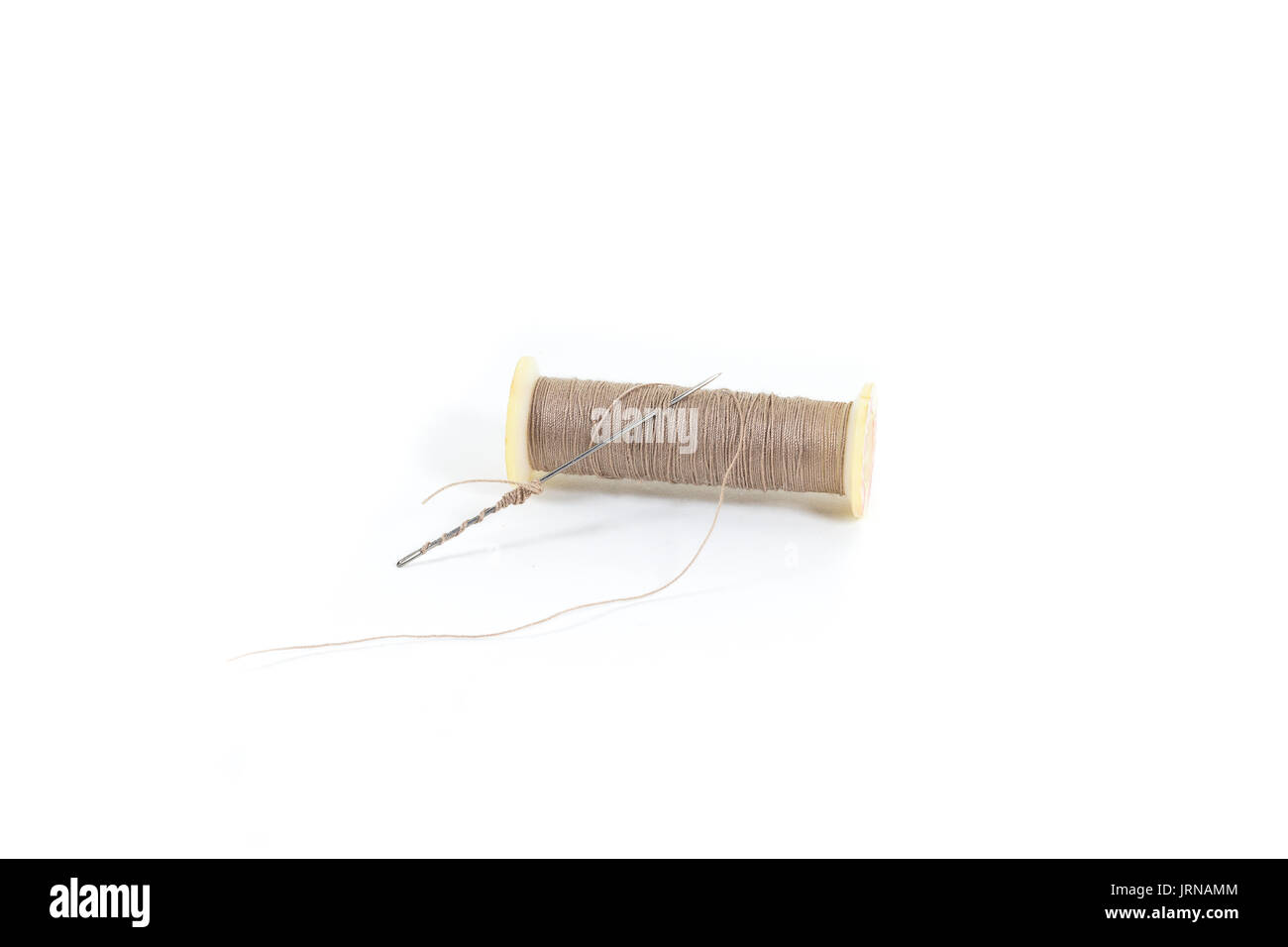 Thread and needle isolated on white background Stock Photo