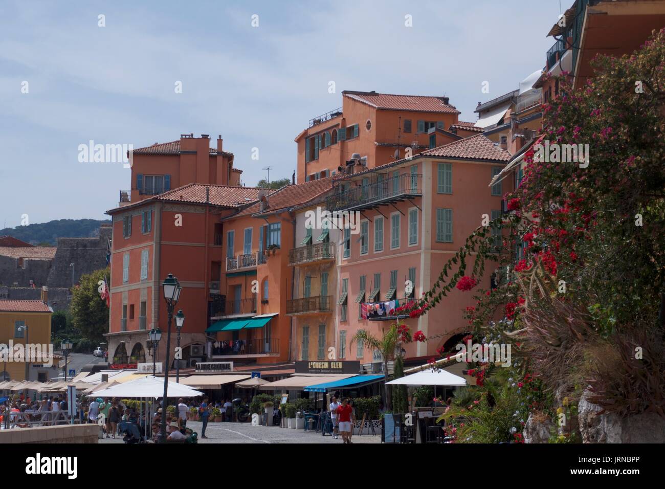 Waterfront street scene with tourists at restaurants and cafes, Beaulieu-sur-Mer, France Stock Photo