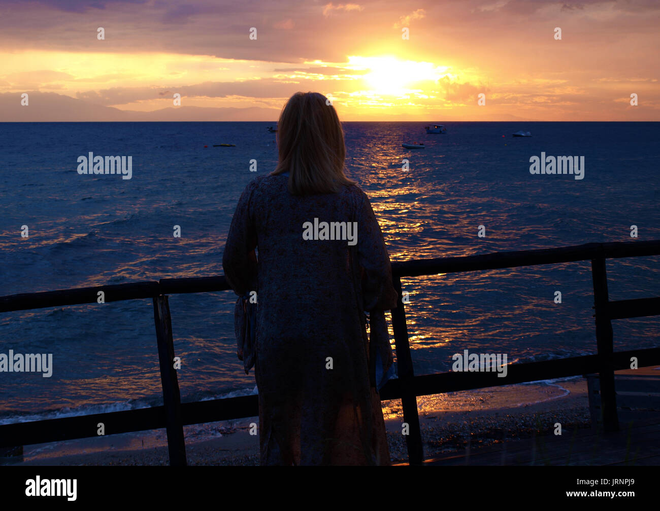 Silhouette of woman watching the sunset hi-res stock photography and ...