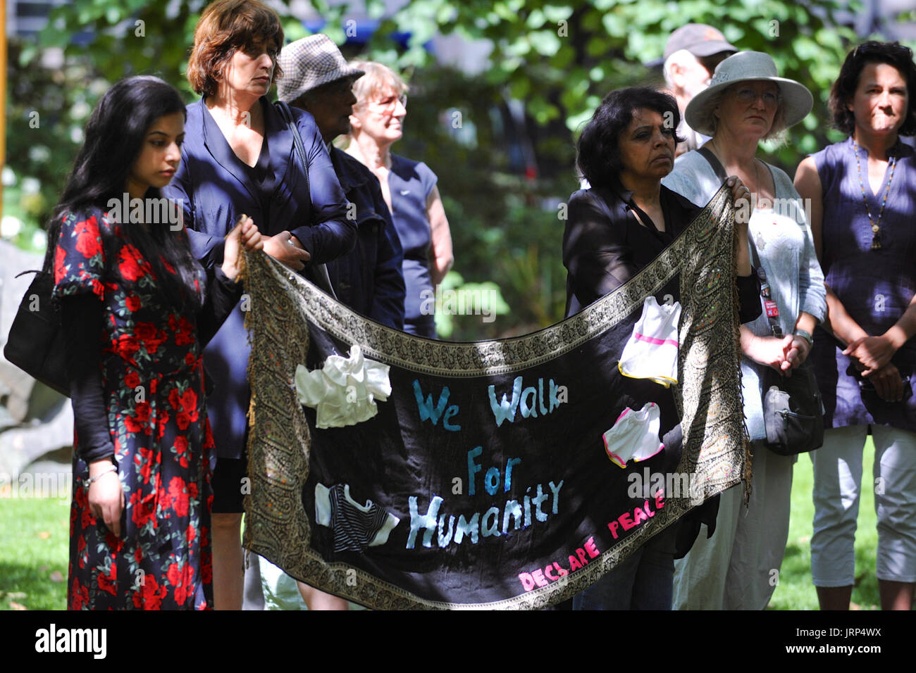 London, UK. 06th Aug, 2017. Anti-nuclear weapons demonstrators holding a banner at the Campaign for Nuclear Disarmament’s annual commemoration of the atomic bombing of Hiroshima, Japan in Tavistock Square, London, United Kingdom.  On 6 August 1967 a cherry tree was planted in the square by Camden Council in memory of the victims of the bombing. Since then an annual ceremony has been held around the tree to remember the attack.  The attack took place at 8.15am, 6 August 1945, when the Enola Gay Boeing B-29 Superfortress bomber dropped the ‘Little Boy’ atomic bomb, the first use of the weapon in Stock Photo