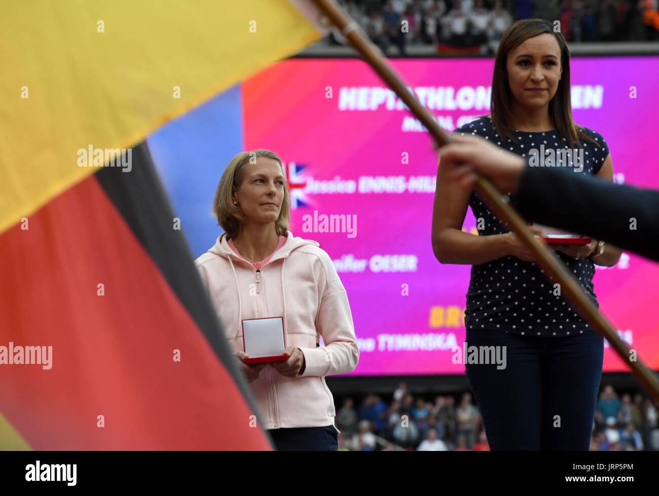 London, UK. 6th Aug, 2017. Former heptathlete Jennifer Oeser (L) of Germany belatedly receives her silver medal in the heptathlon of 2011 at the IAAF World Championships at the Olympic Stadium in Athletics in London, UK, 6 August 2017. Britain's Jessica Ennis (r) was named world champion. Oeser moved from third to second place after then-champion Tatyana Chernova of Russia was disqualified for doping. Photo: Bernd Thissen/dpa/Alamy Live News Stock Photo