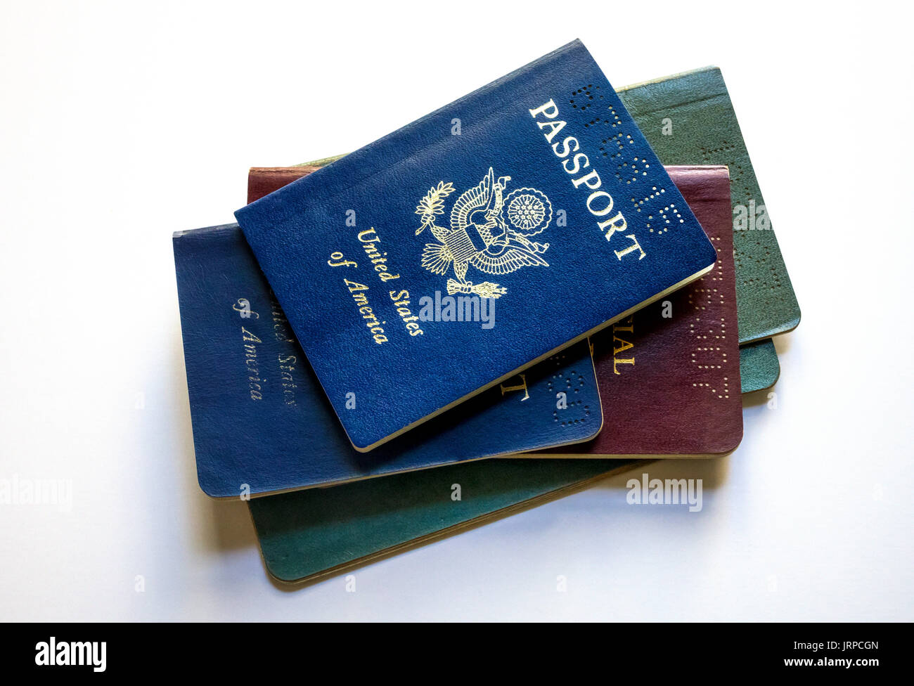 A stack of expired US passports against a white background Stock Photo
