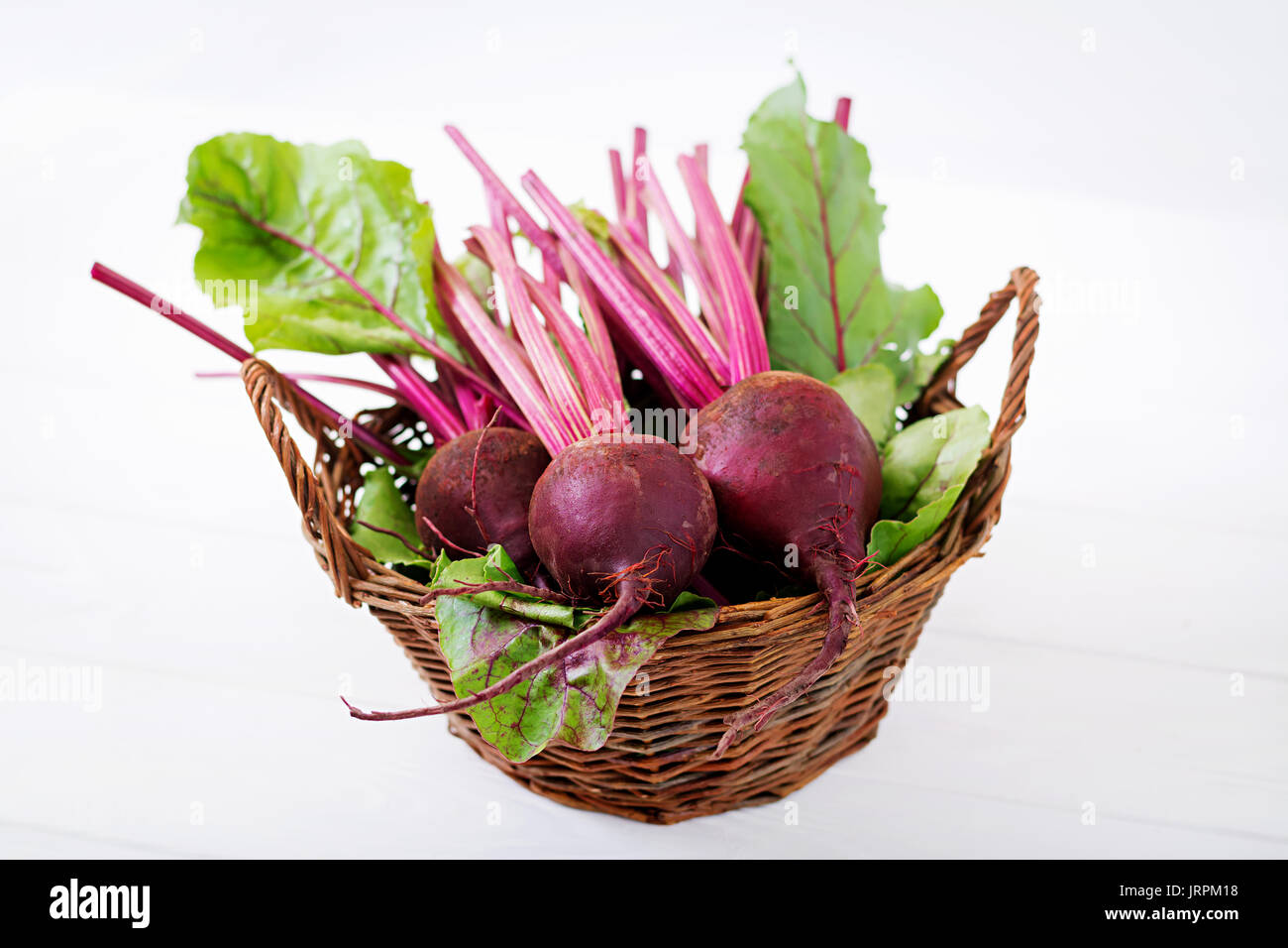 Young beetroot with a tops on a white background. Stock Photo