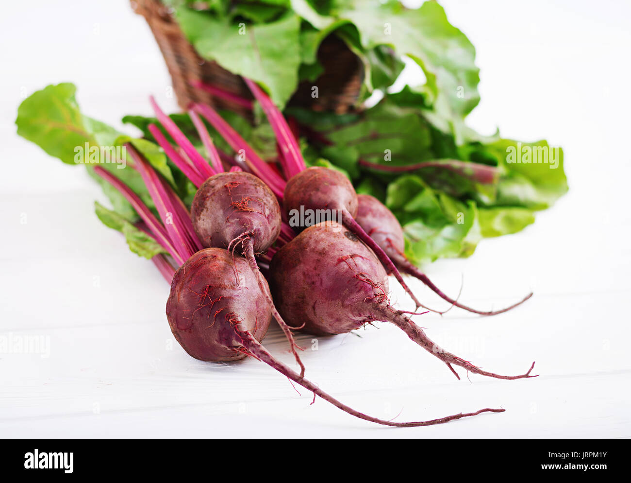 Young beetroot with a tops on a white background. Stock Photo