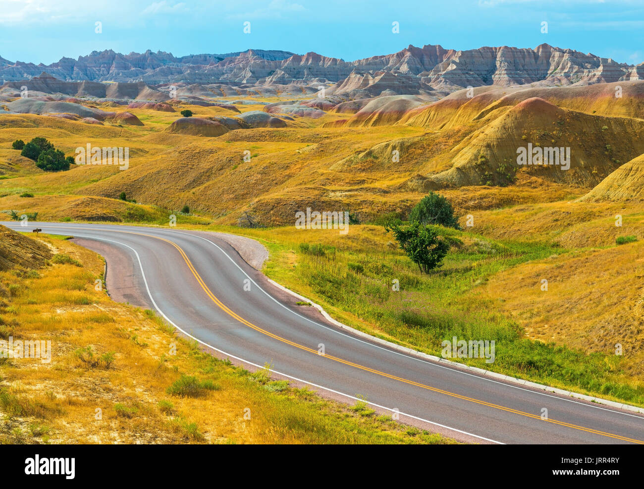 Yellow mountain road with geological stone formations inside Badlands National Park near Rapid City in the state of South Dakota, USA. Stock Photo