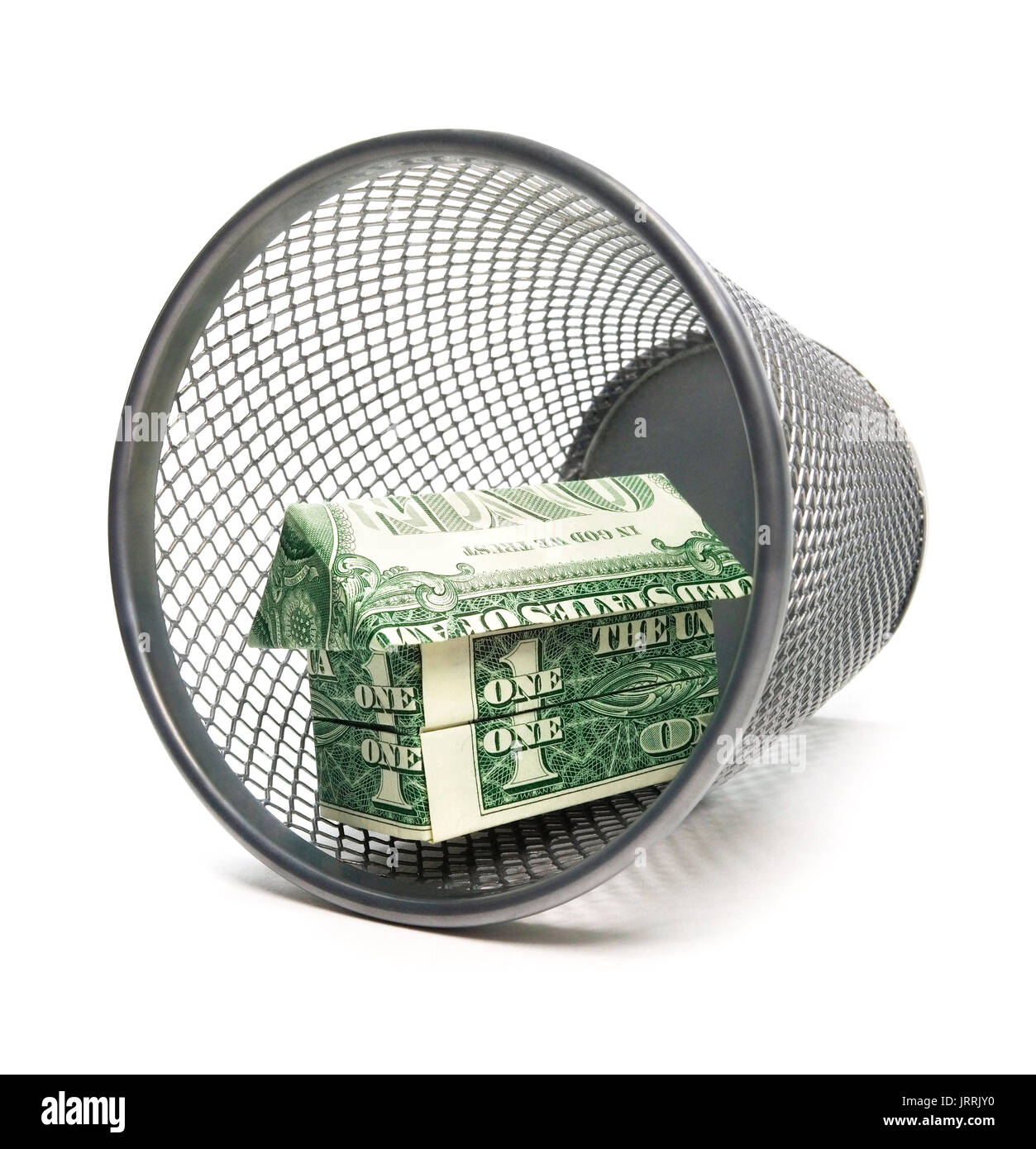 Isolated trash bin with a origami cash house. Stock Photo