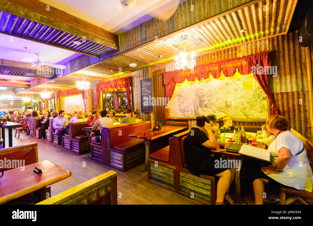 People having dinner in the evening at the Iron Bar, Macrossan Street