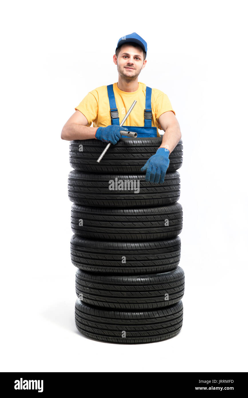 Car tire service repairman, white background, garage worker with tyres