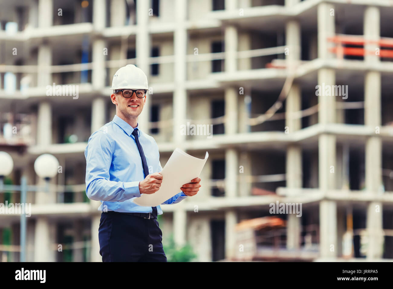 Handsom construction engineer at the construction site looking at the camera Stock Photo
