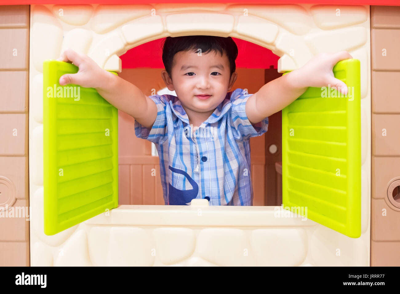 Kid Window Toy Happy Asian child Boy playing with window toy house in playground Stock ...