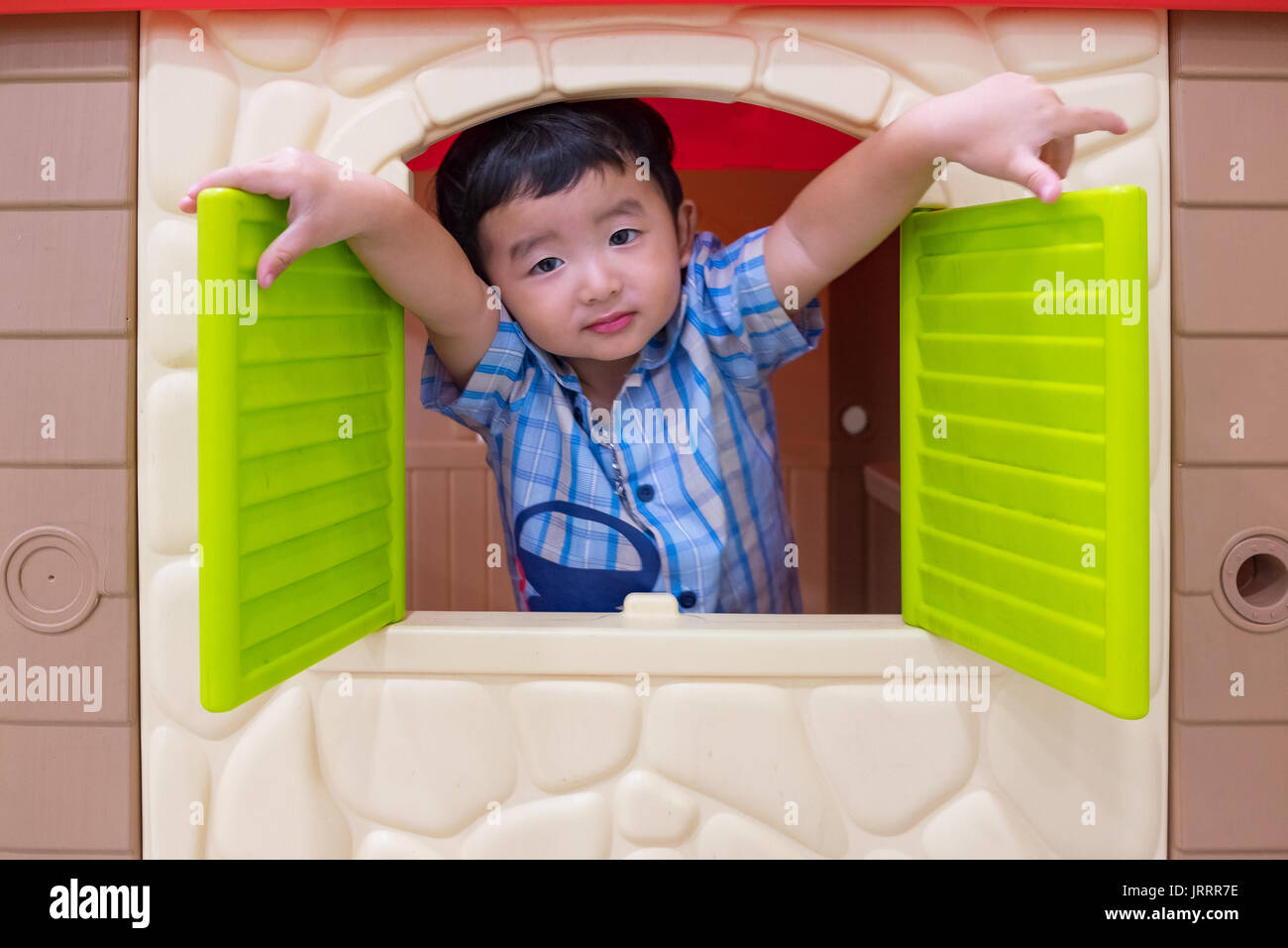 Kid Window Toy Happy Asian child Boy playing with window toy house in playground Stock ...