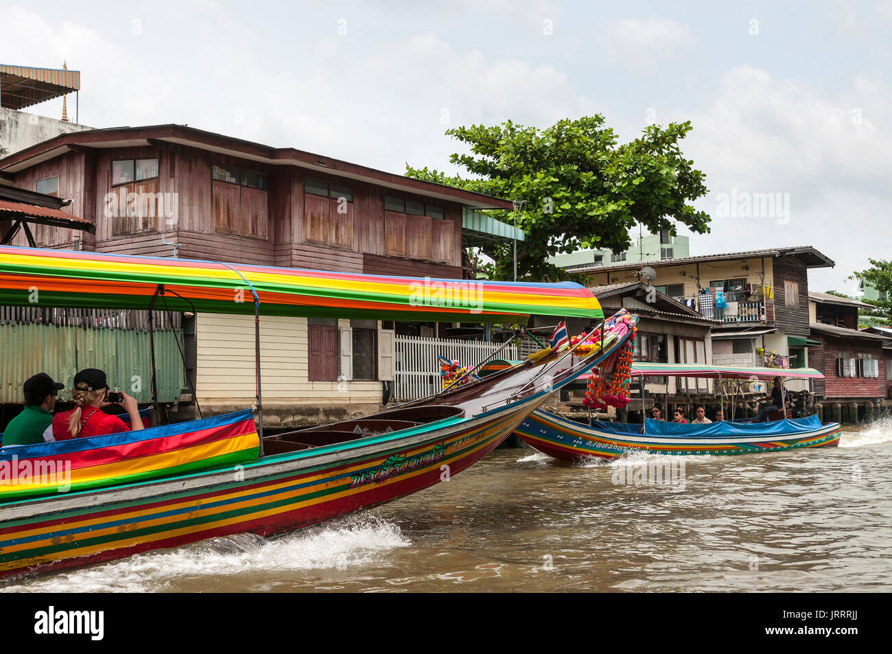 Tourists touring the Khlongs in long-tail boats, Thonburi, Bangkok, Thailand Stock Photo