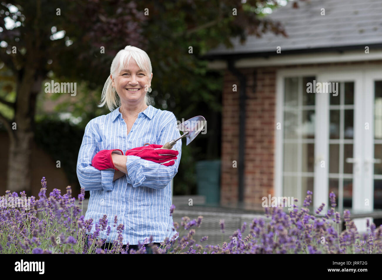 Portrait Of Mature Woman Working In Garden Stock Photo