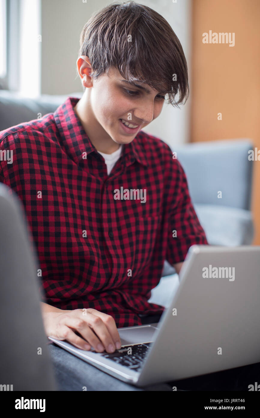 Teenage Boy Working On Laptop At Home Stock Photo - Alamy
