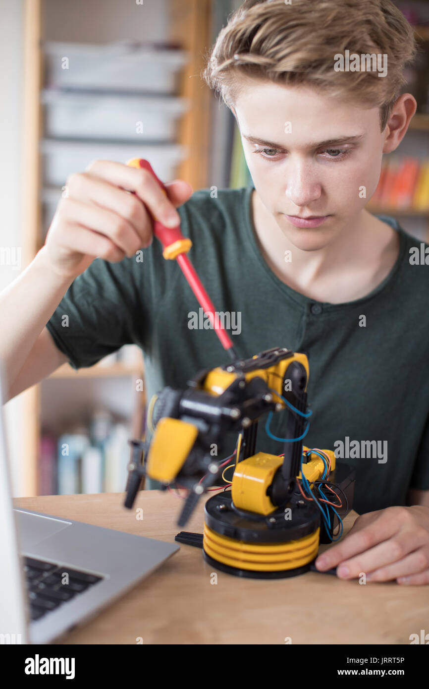 Teenage Boy Building Robotic Arm At School Stock Photo