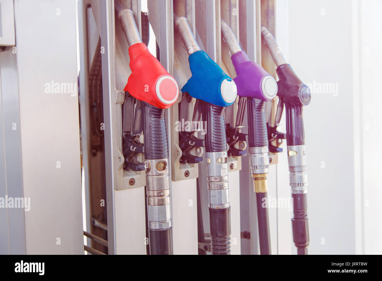 Fuel pump with gasoline and diesel handles dispenser at petrol filling station. Stock Photo
