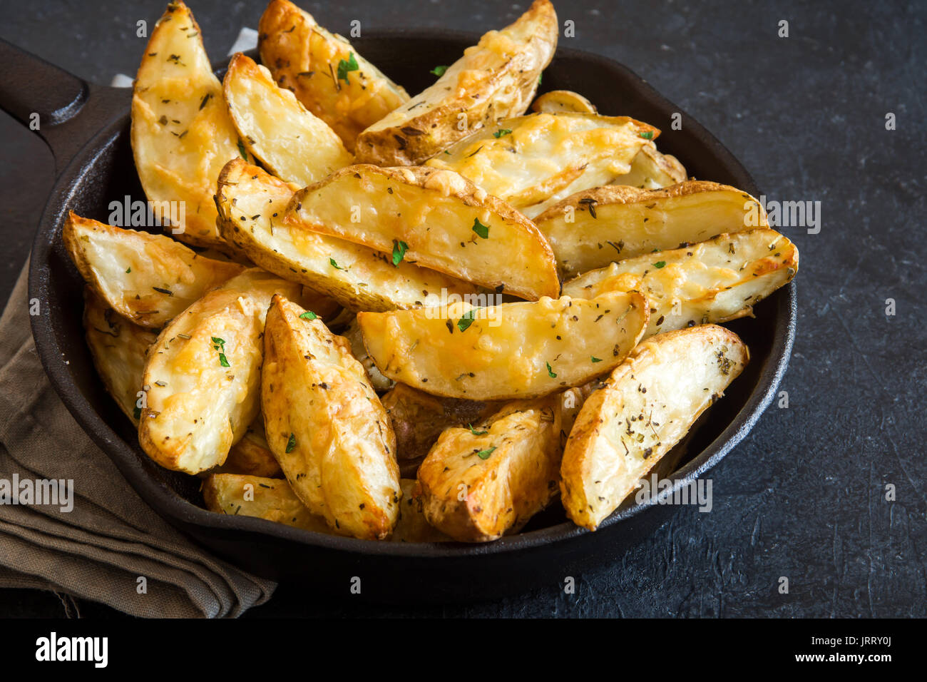 Baked Potato Wedges With Cheese And Herbs And Tomato Sauce On Black Background Homemade Organic Vegetable Vegan Vegetarian Potato Wedges Snack Food Stock Photo Alamy