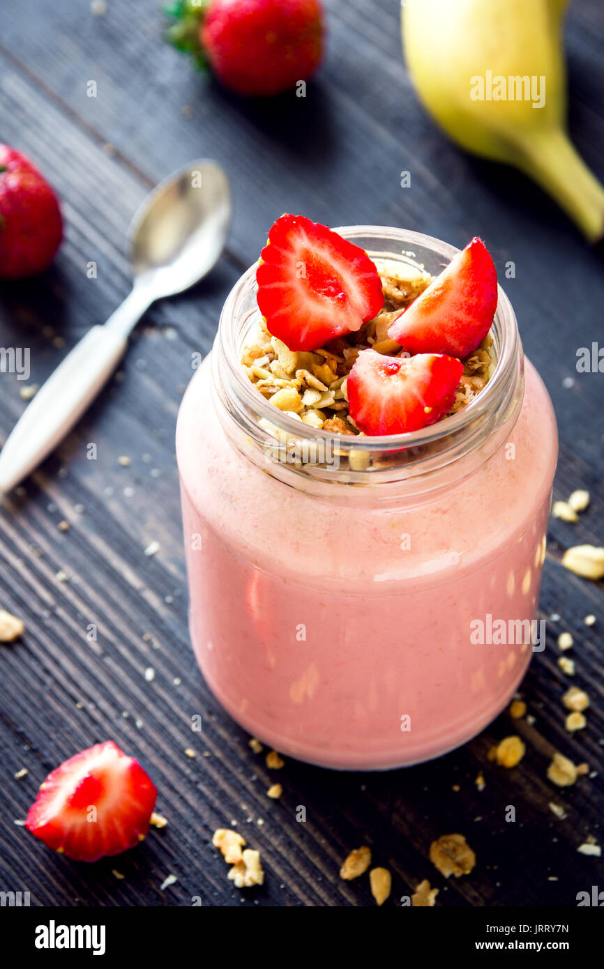 Strawberry and banana smoothie with homemade granola. Healthy breakfast or snack. Banana and