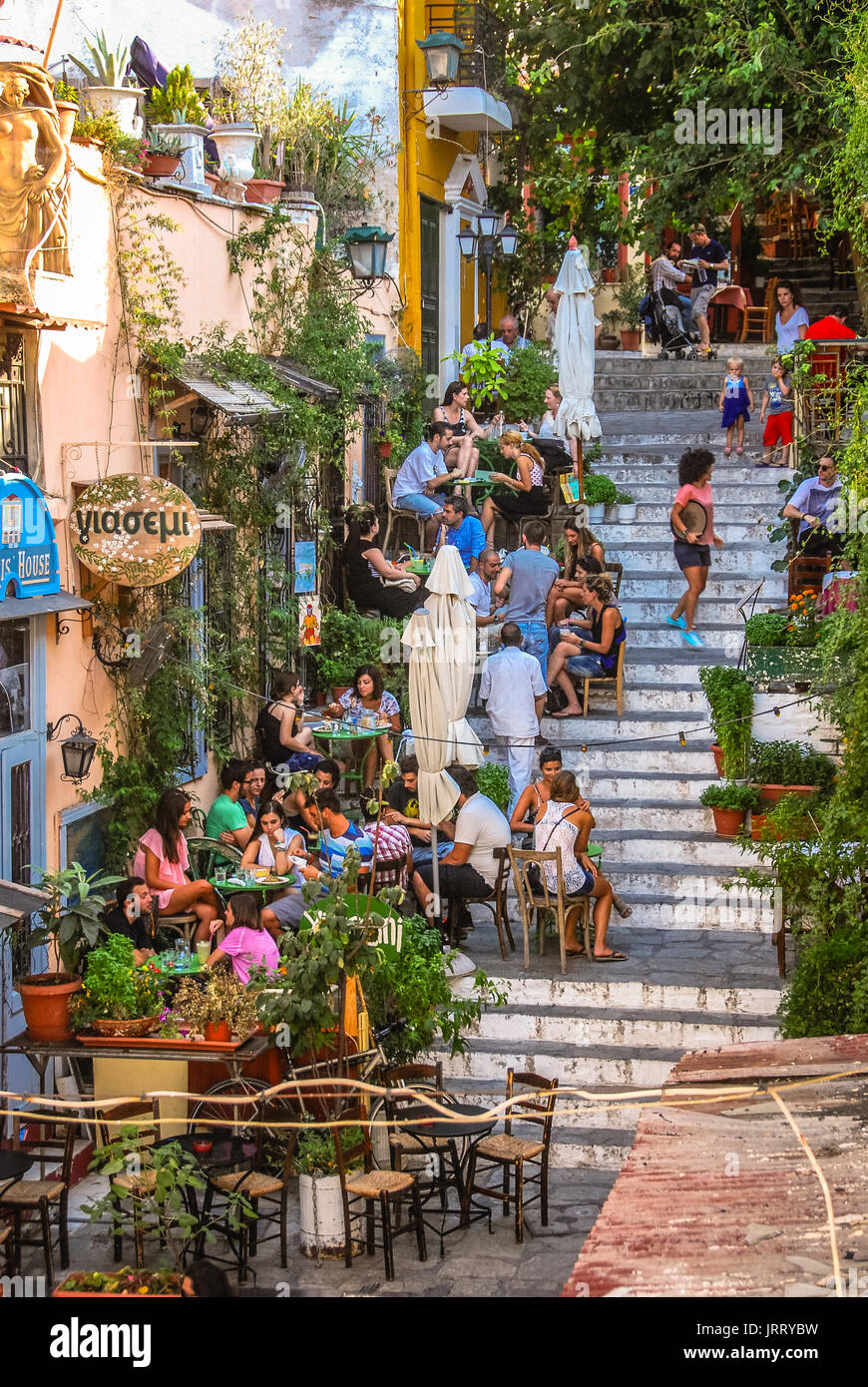 Athens, Greece - August 2, 2012: People dining outside on the stairs in the Plaka district of Athens. Stock Photo