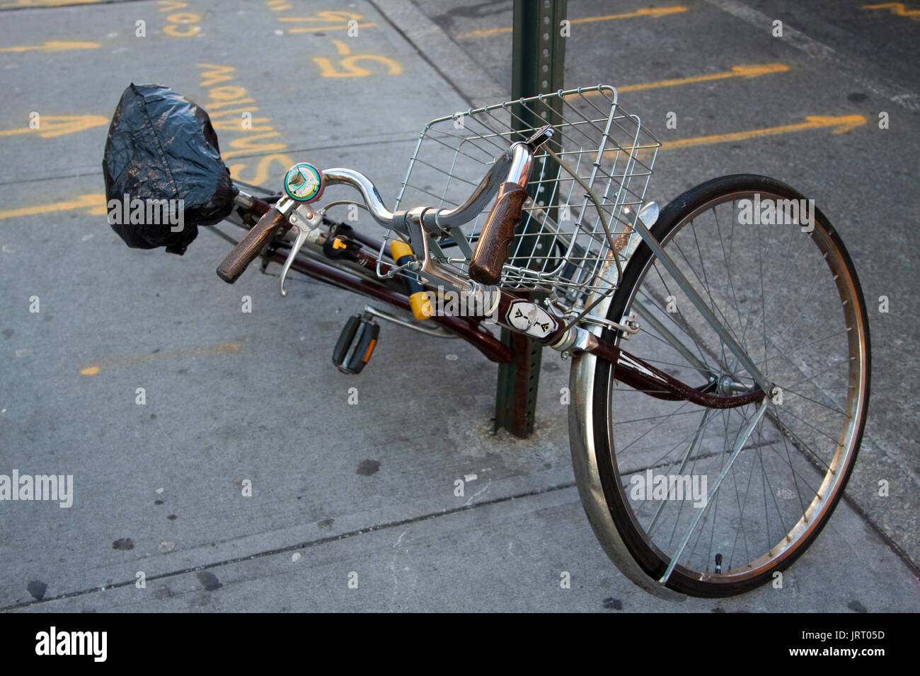 Bicycle, fallen down while attached to lamp post in Manhattan, NY. Stock Photo