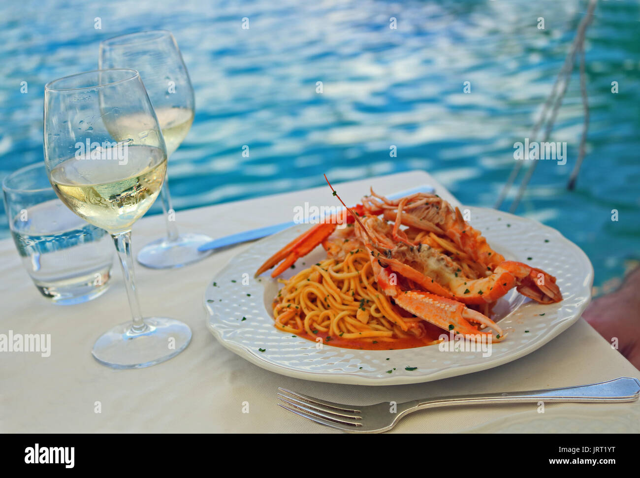 Outdoor dining wine and crustacean pasta,Italy Stock Photo - Alamy