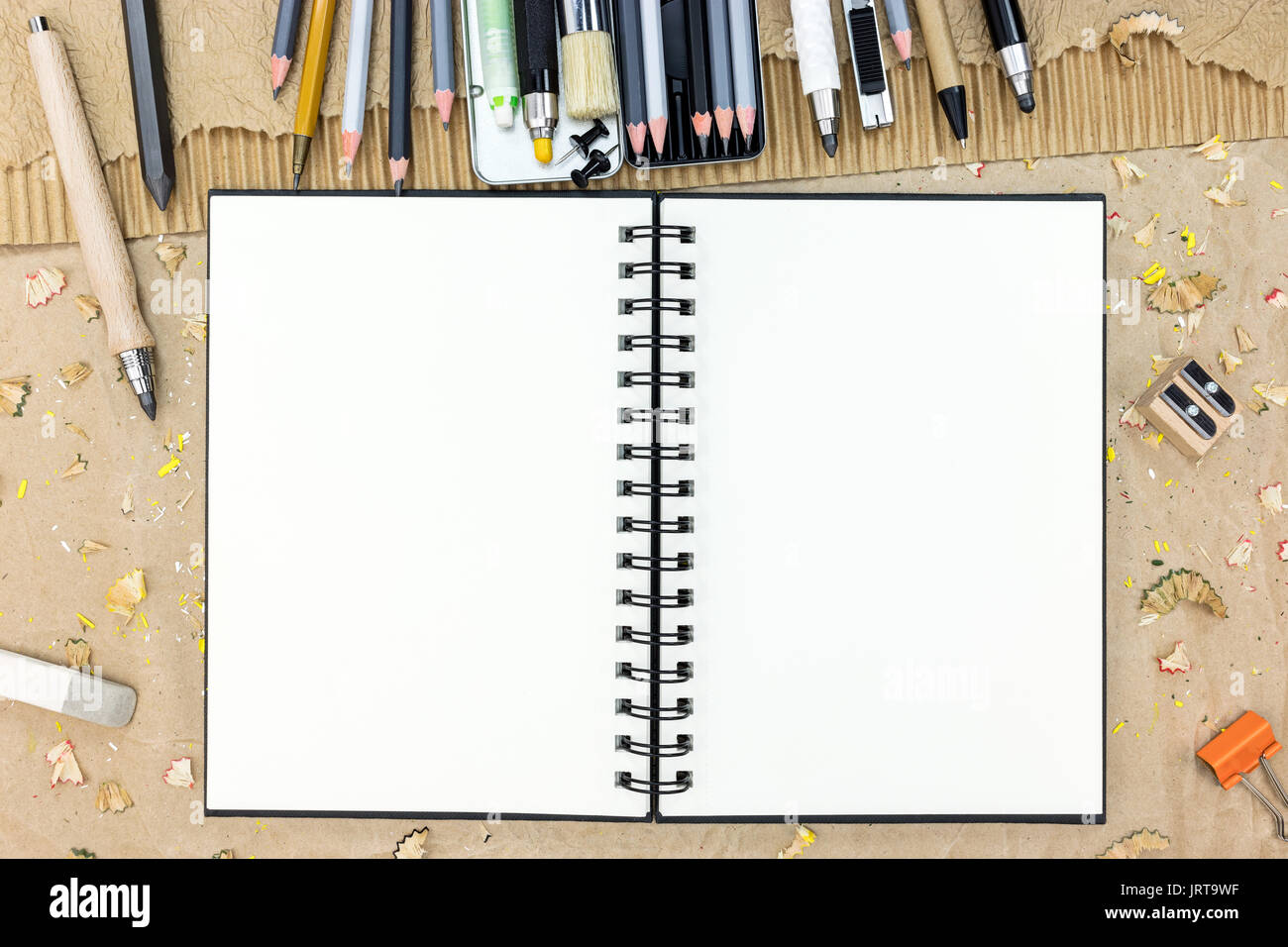 blank sketchbook and pencils for drawing on brown artistic background top view Stock Photo