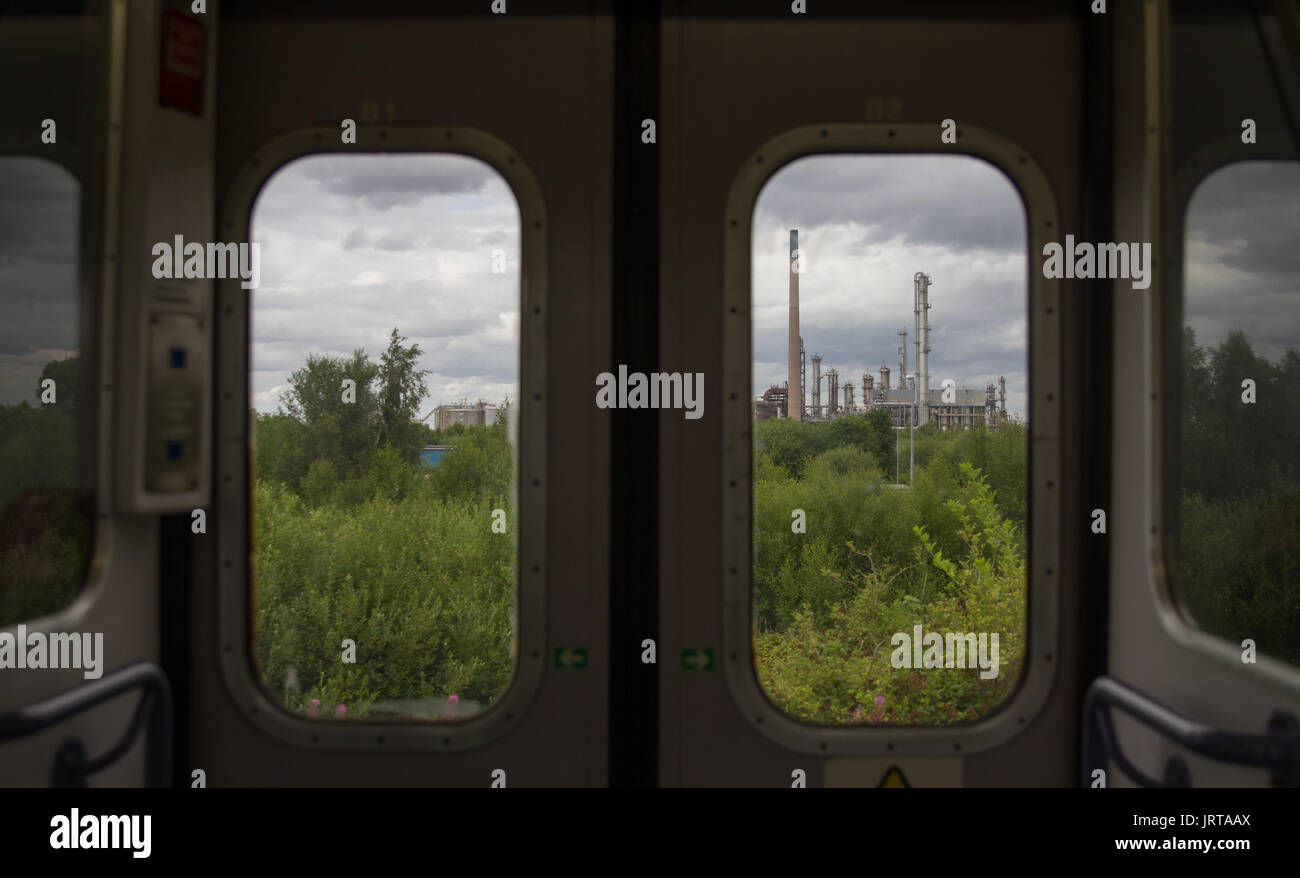 Industrial Landscape - Stanlow and Thornton and the Mersey Estuary from the train window. Stock Photo