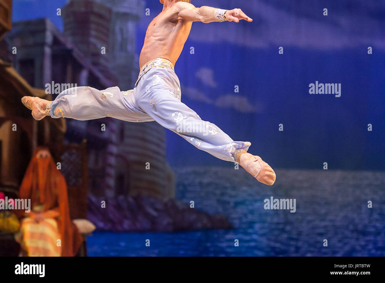 gravity, dance, rehearsal concept. strong caucasian man dressed in silk