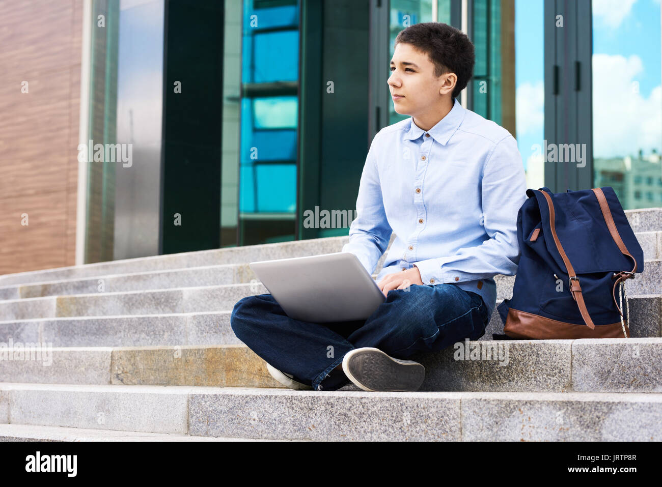Pensive Schoolboy with Laptop Outdoors Stock Photo