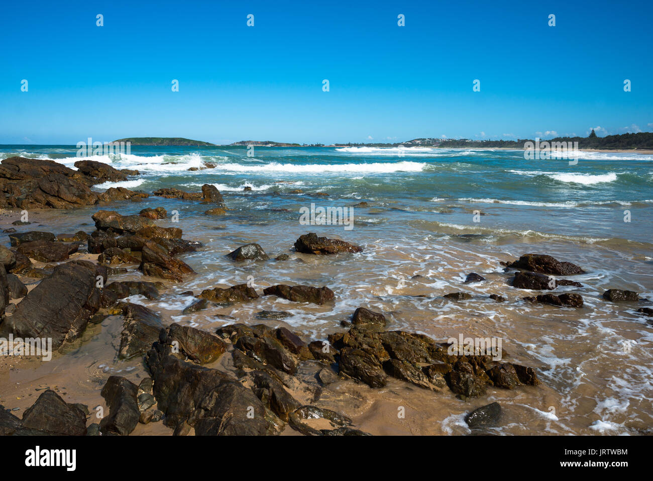 Far end of Park's beach where it reaches Macauleys Headland, Coffs Harbour coast, New South Wales, Australia. Stock Photo