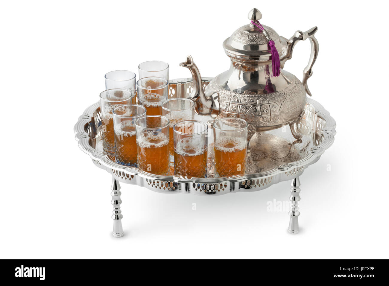 Traditional festive Moroccan silver tea set and glasses on white